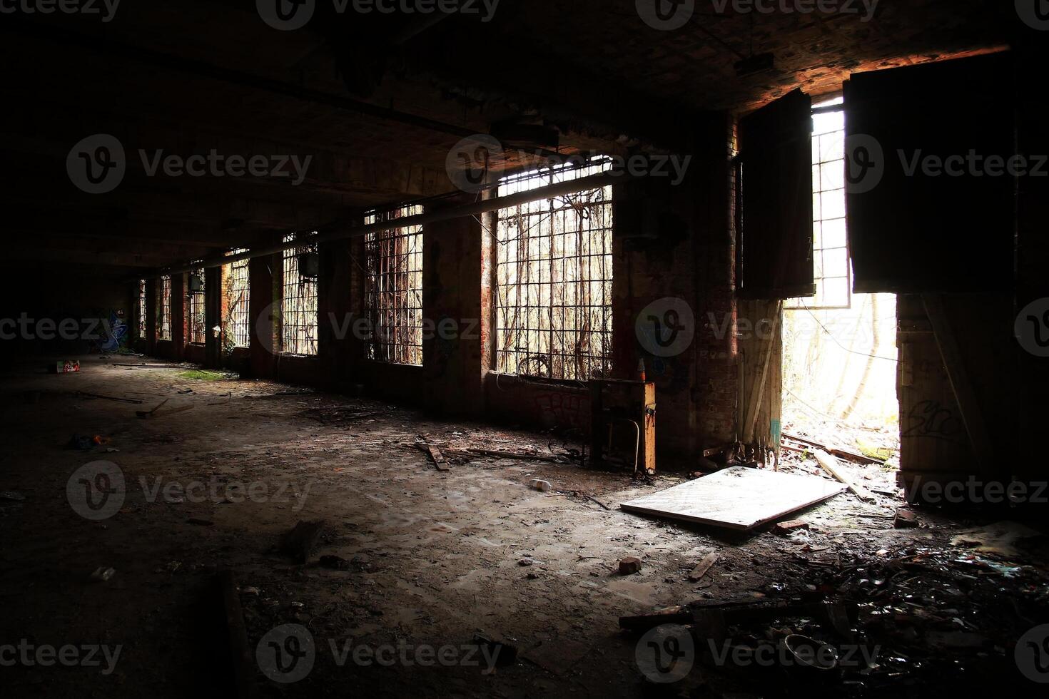 Dark indoor shot of abandoned factory hall in Germany photo