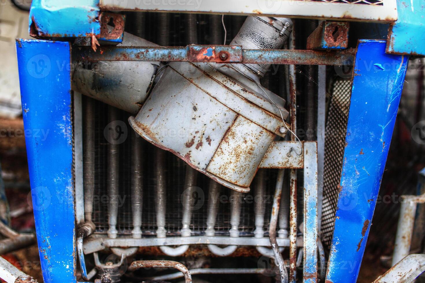 Detail of broken air filter of an old tractor photo