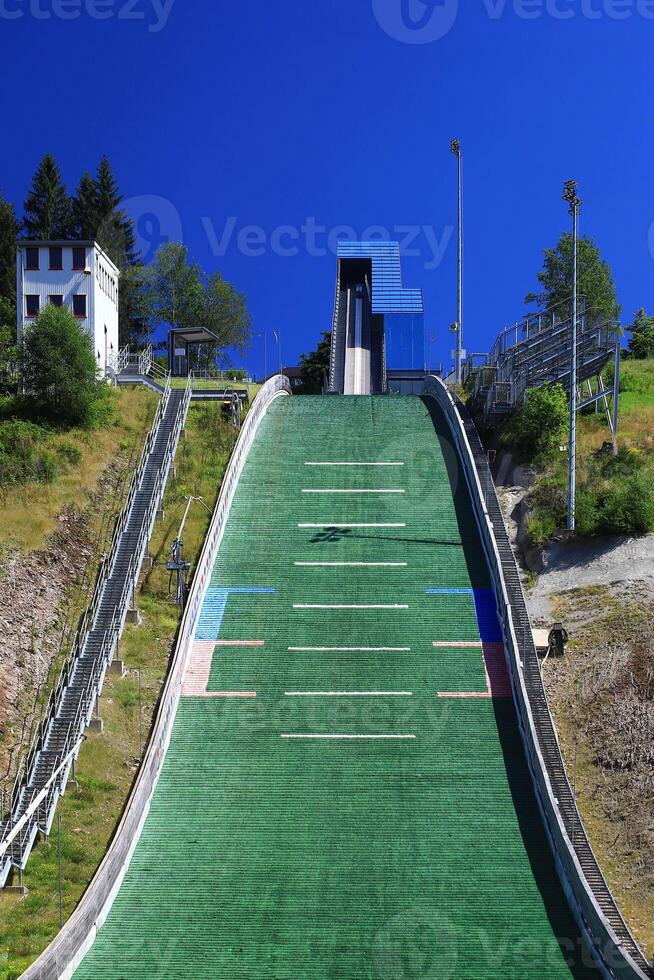 Close-up view of ski jump ramp with stairs and blue sky background in Oberhof, Germany photo