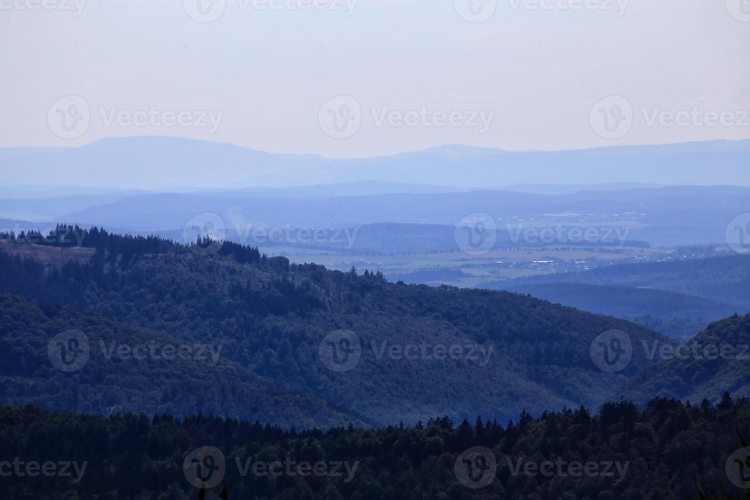 Dense forest landscape overlooking Thuringian forest with layers of trees and distant horizon photo