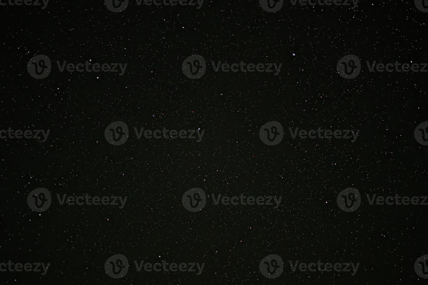 Starry night sky filled with countless visible stars against a vast dark backdrop photo