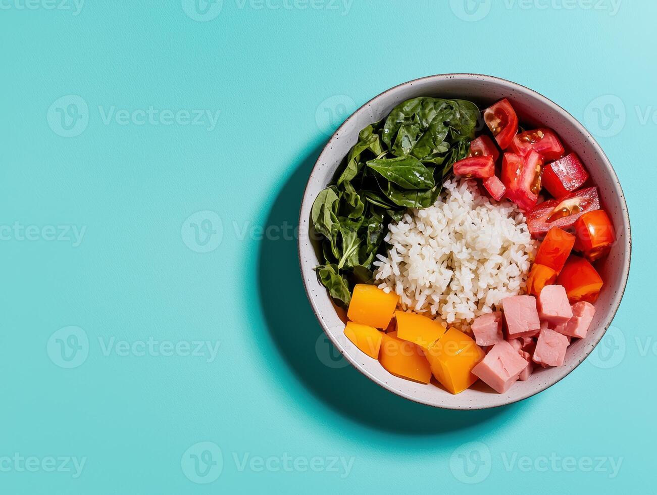 Healthy and delicious rice bowl with fresh vegetables and ham photo