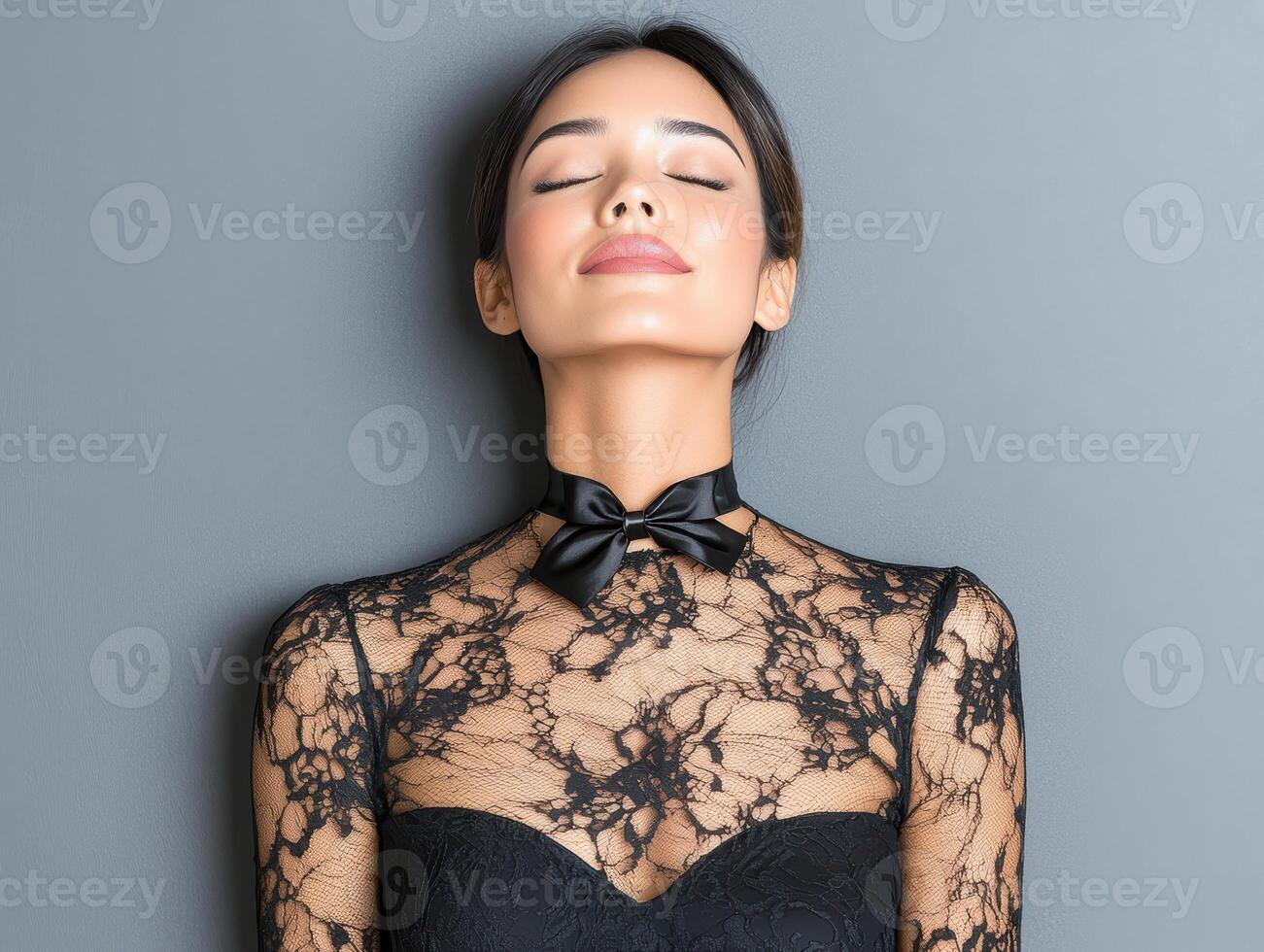 Beautiful woman in black lace top and bow tie photo