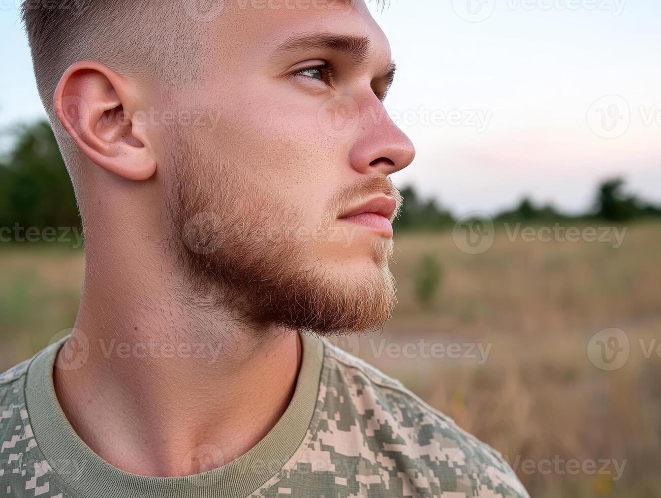 Profile of a young man in military uniform looking to the side photo