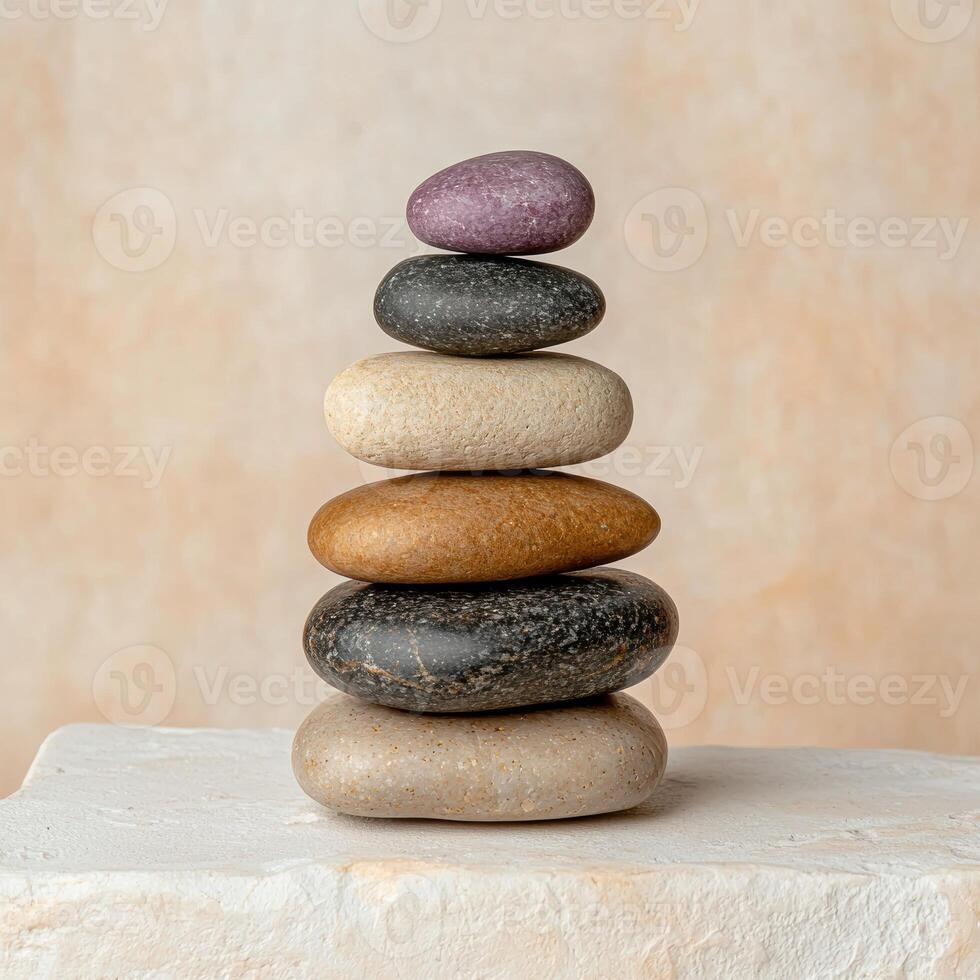 Stack of colorful stones on a white surface photo