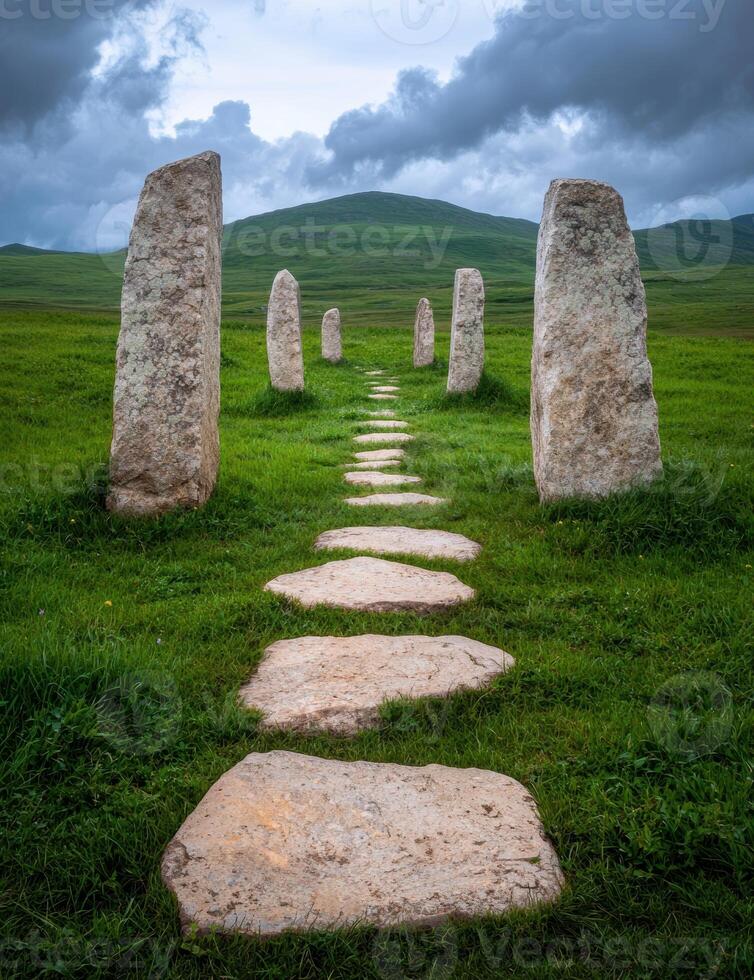 Stone path leading to standing stones in a green field photo