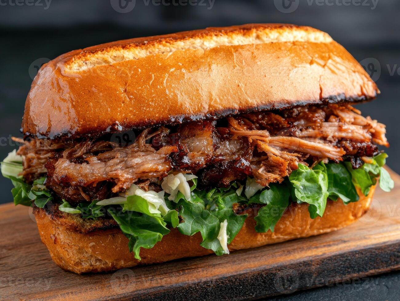 Close up of a delicious pulled pork sandwich on a wooden board photo