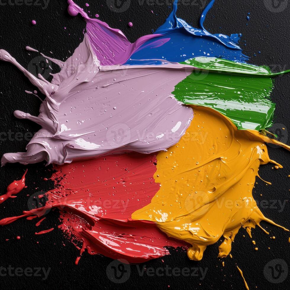 Abstract colorful paint splatters on black background photo