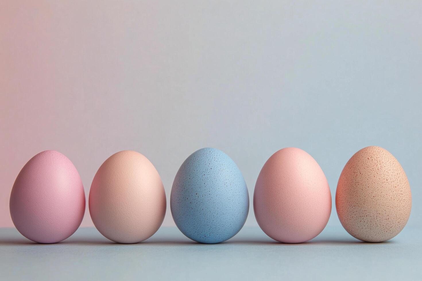 Colorful pastel eggs arranged in a row on a light surface for festive decoration photo
