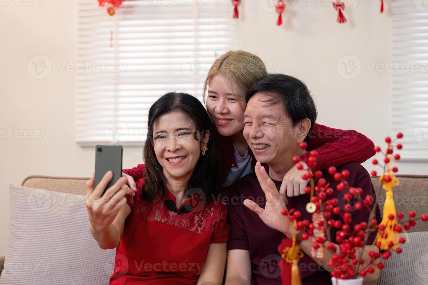Family celebrates chinese new year together home candid photo cozy living room joyful moment generational bonds