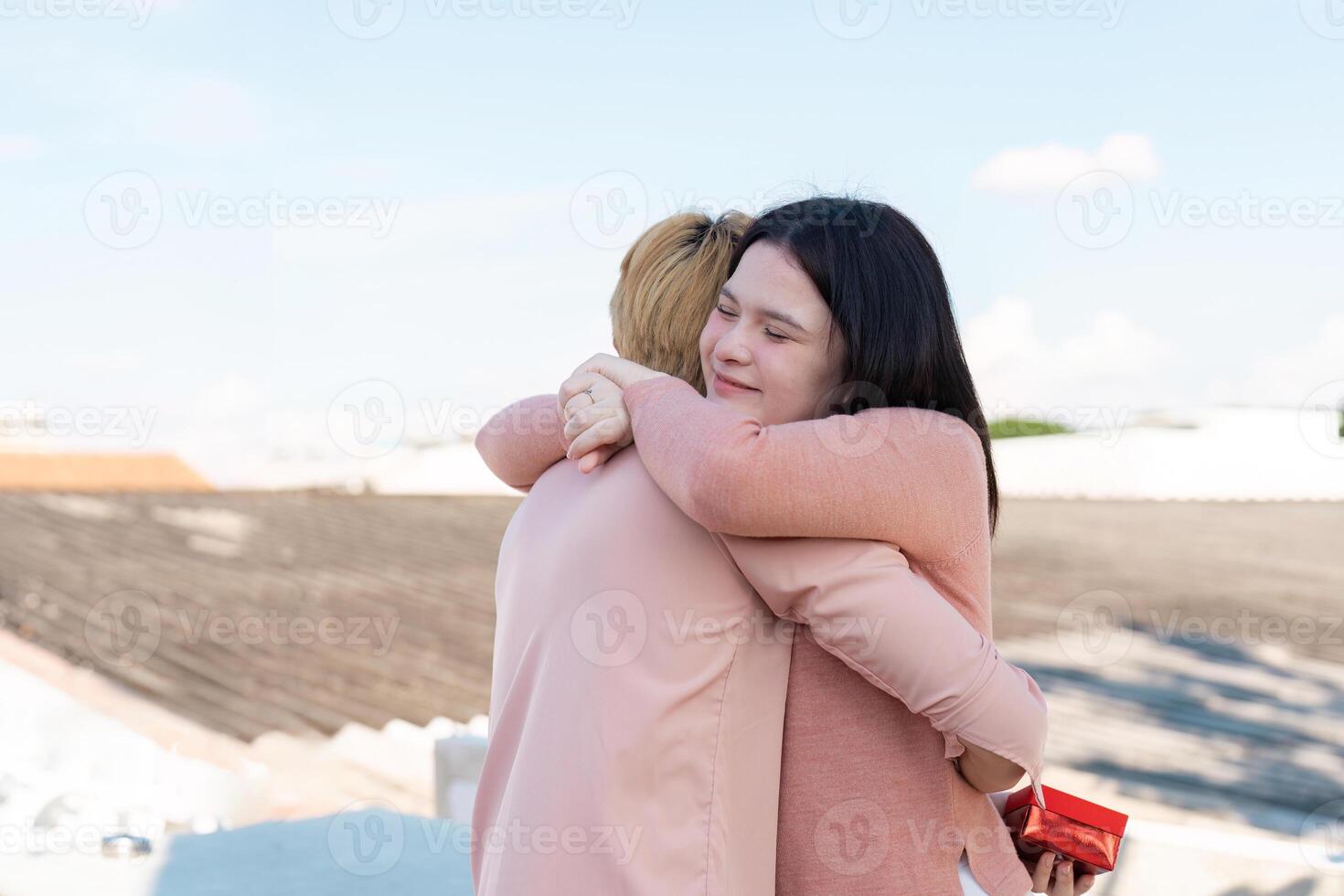 Couple embracing on rooftop valentine day surprise intimate setting joyful moment photo