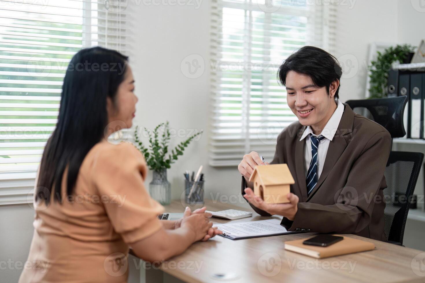 Real estate consultation office setting professional interaction informative environment engaging viewpoint trust building photo