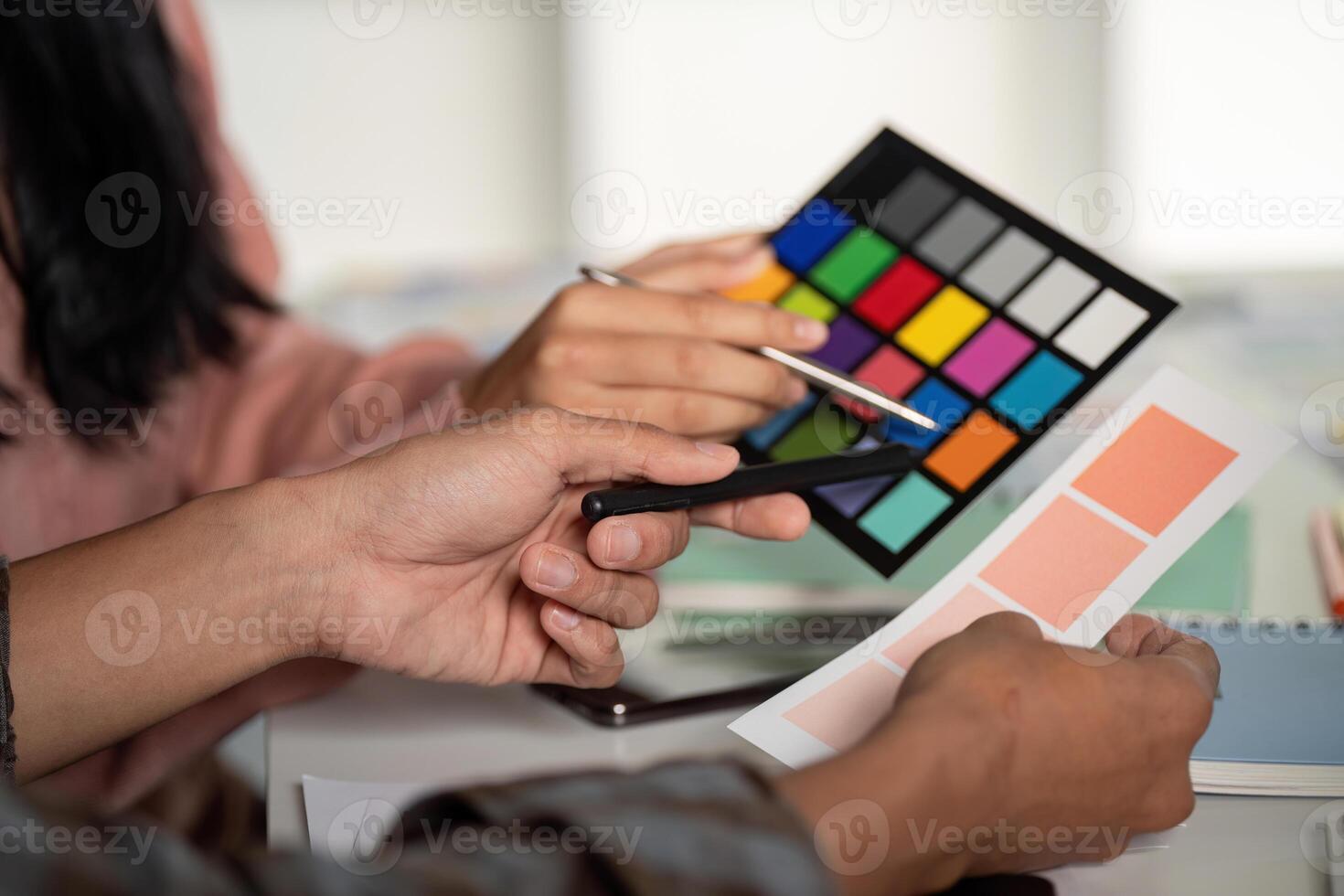 Design team collaborating on color selection graphics at modern office creative environment close-up view for effective branding photo