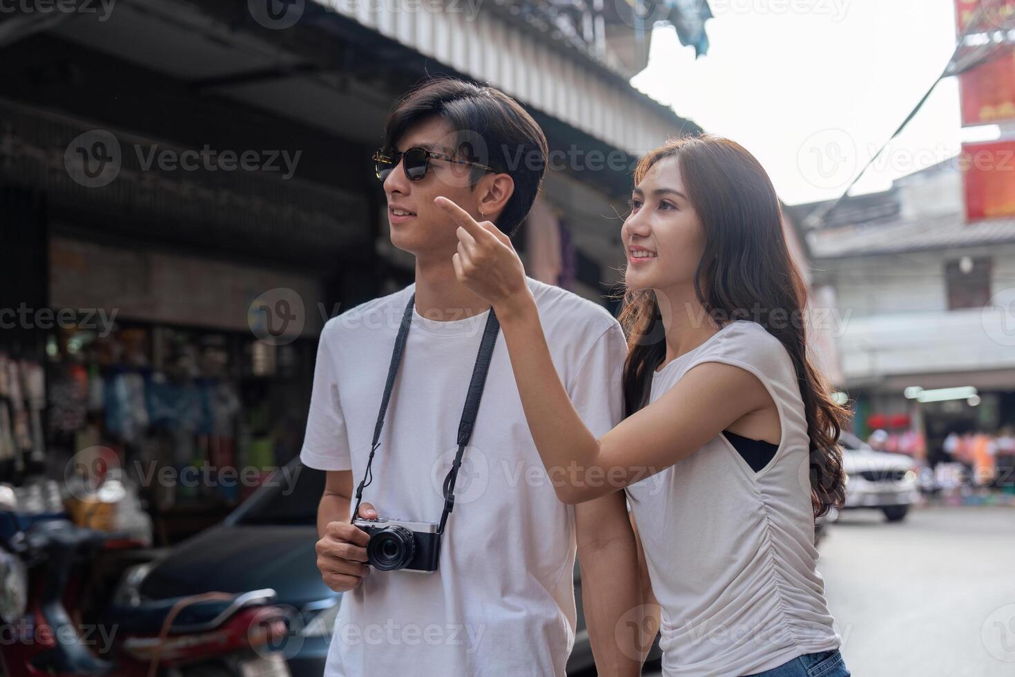 Couple traveling in a vibrant market street urban environment candid perspective together photo