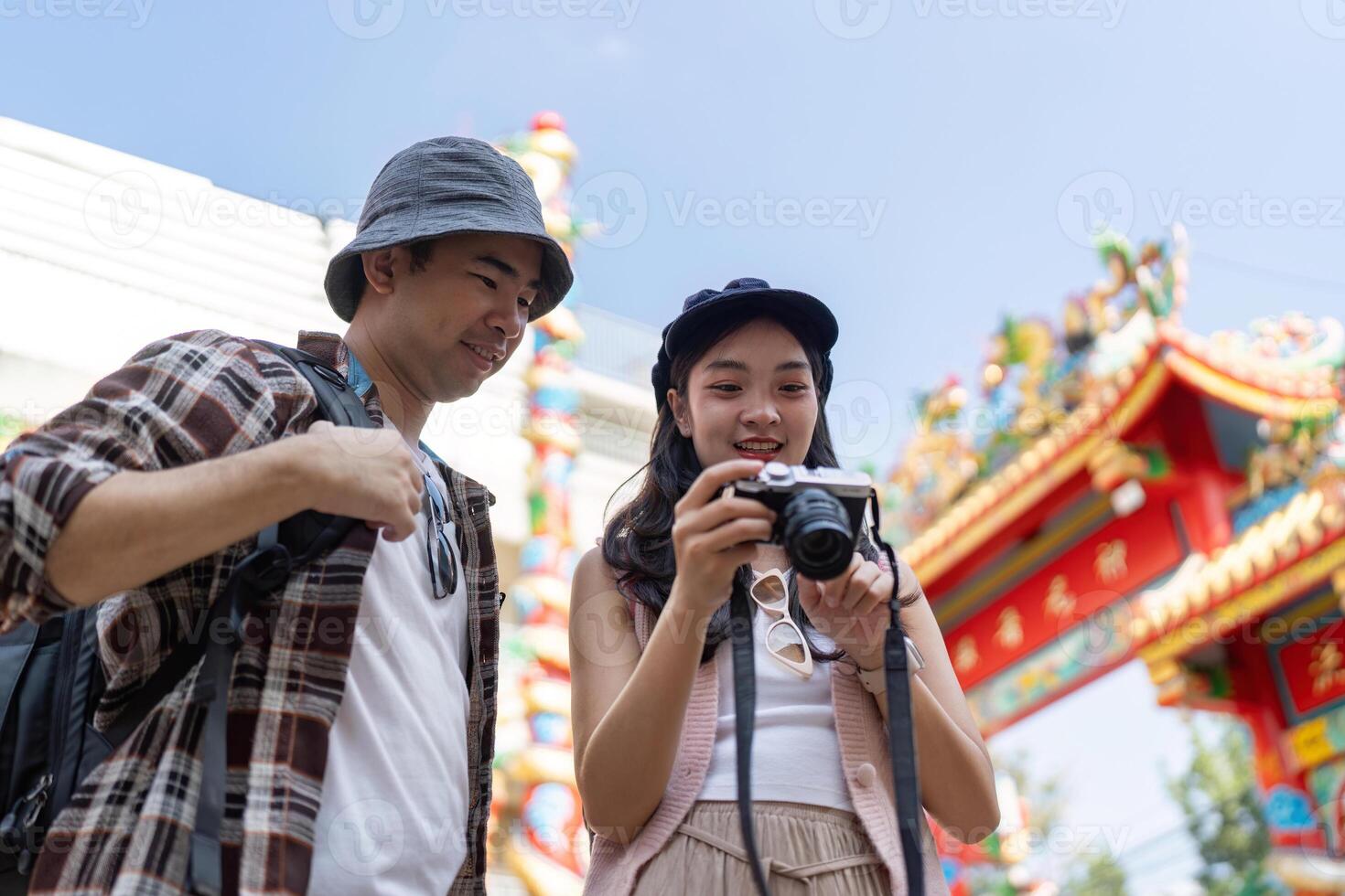 Traveling couple captures memories at cultural festival vibrant streets outdoor joyful experience photo