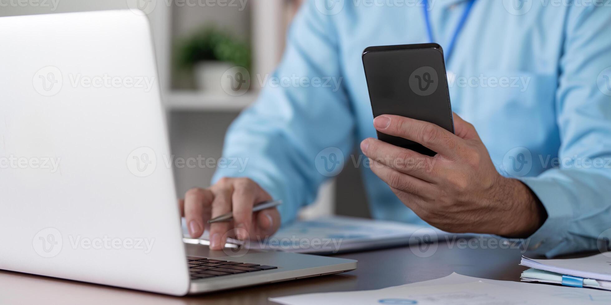 Business professional using laptop and smartphone in modern office environment focus on productivity and connectivity photo