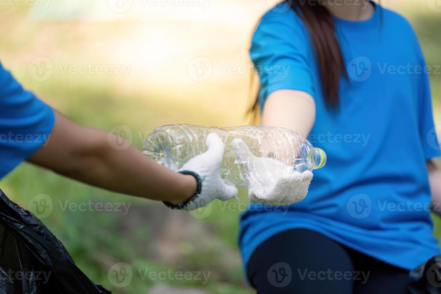 Family volunteers collecting garbage together in nature community event positive action outdoor environment photo