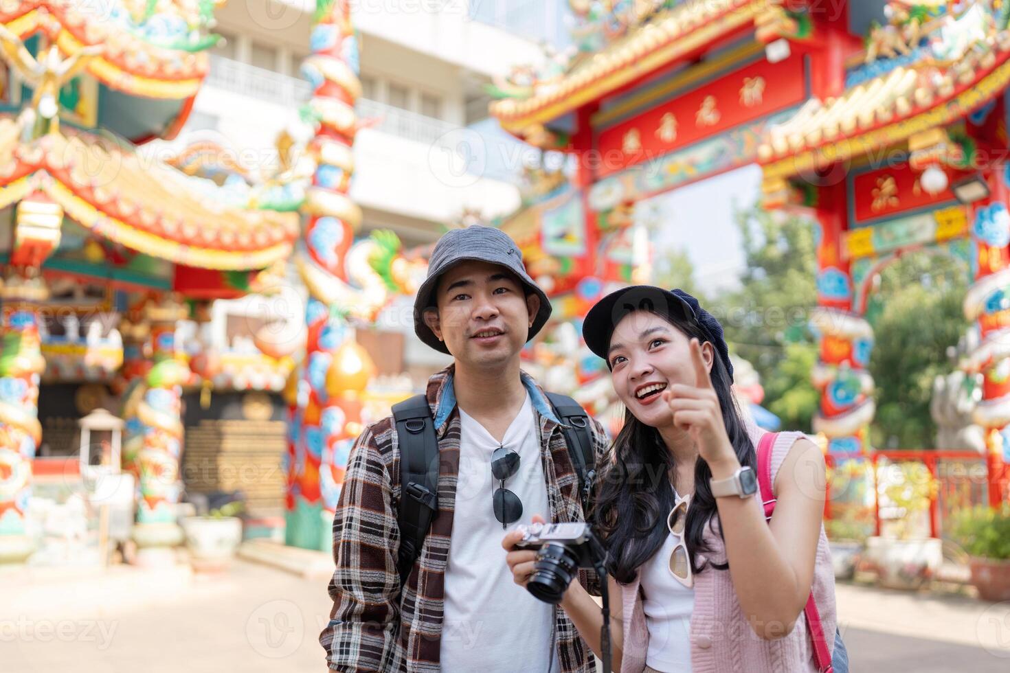 Traveling couple captures moments at vibrant cultural site city urban setting eye level adventure photo