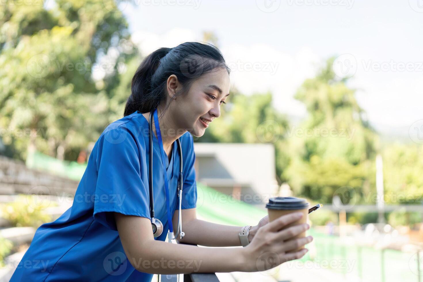 Nurse enjoying coffee break healthcare facility lifestyle image outdoor setting positive mood doctor nurse wellbeing concept photo