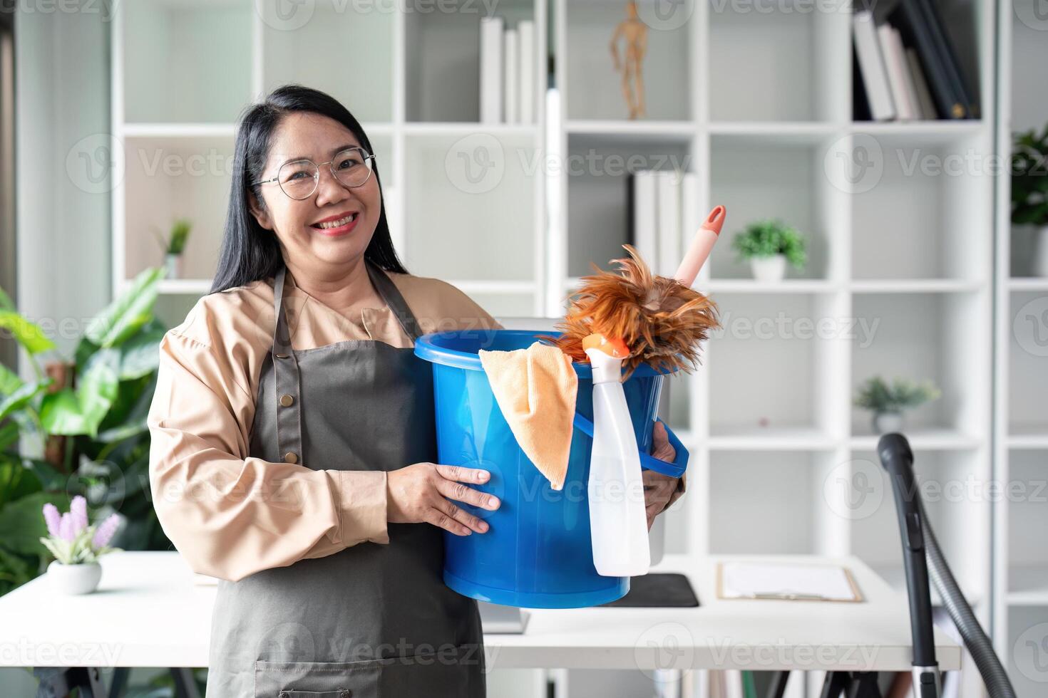 Housekeeper cleaning action modern home image of maid with bucket bright environment smiling viewpoint concept of cleanliness photo