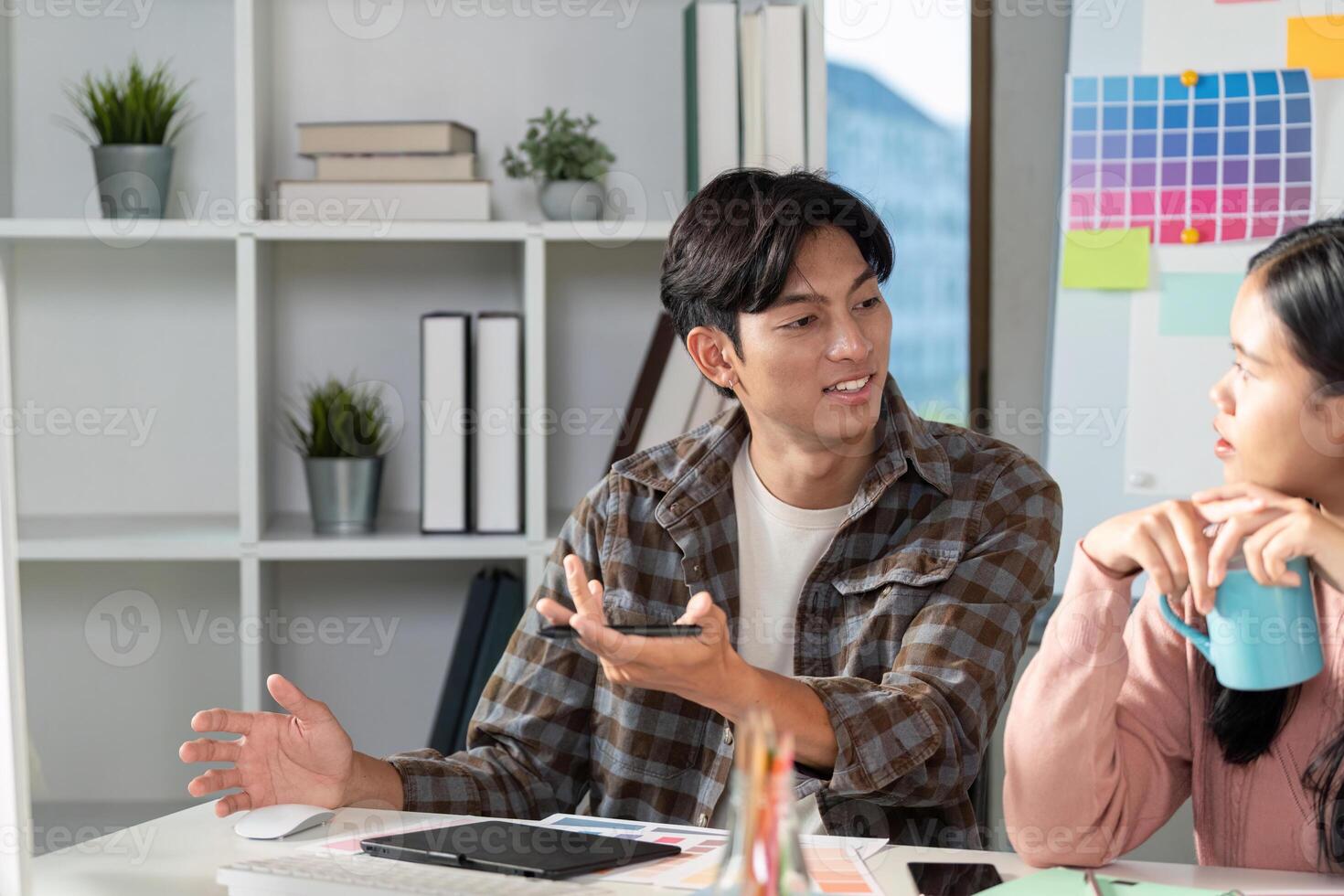 Team meeting on graphic design strategies with color charts modern office collaborative environment engaged viewpoint photo