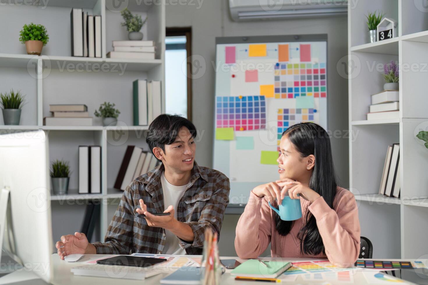 Collaborative design team discussing graphics ideas in modern office space creative environment engaging viewpoint photo