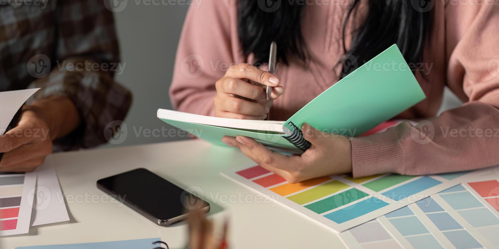 Creative design team collaborating on graphics in a modern workspace environment photo