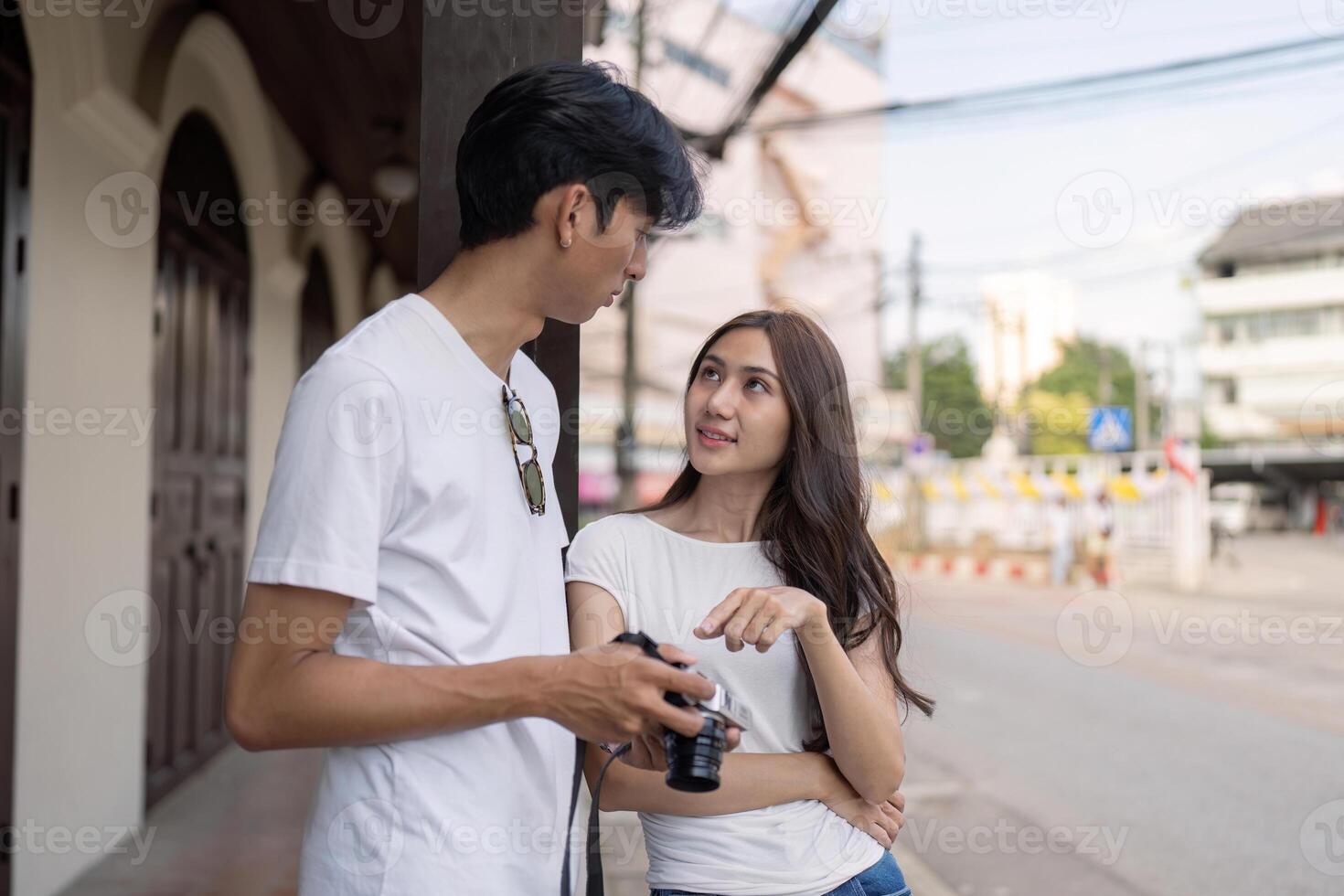 Traveling couple captures memories in city streets outdoor natural light intimate viewpoint photo