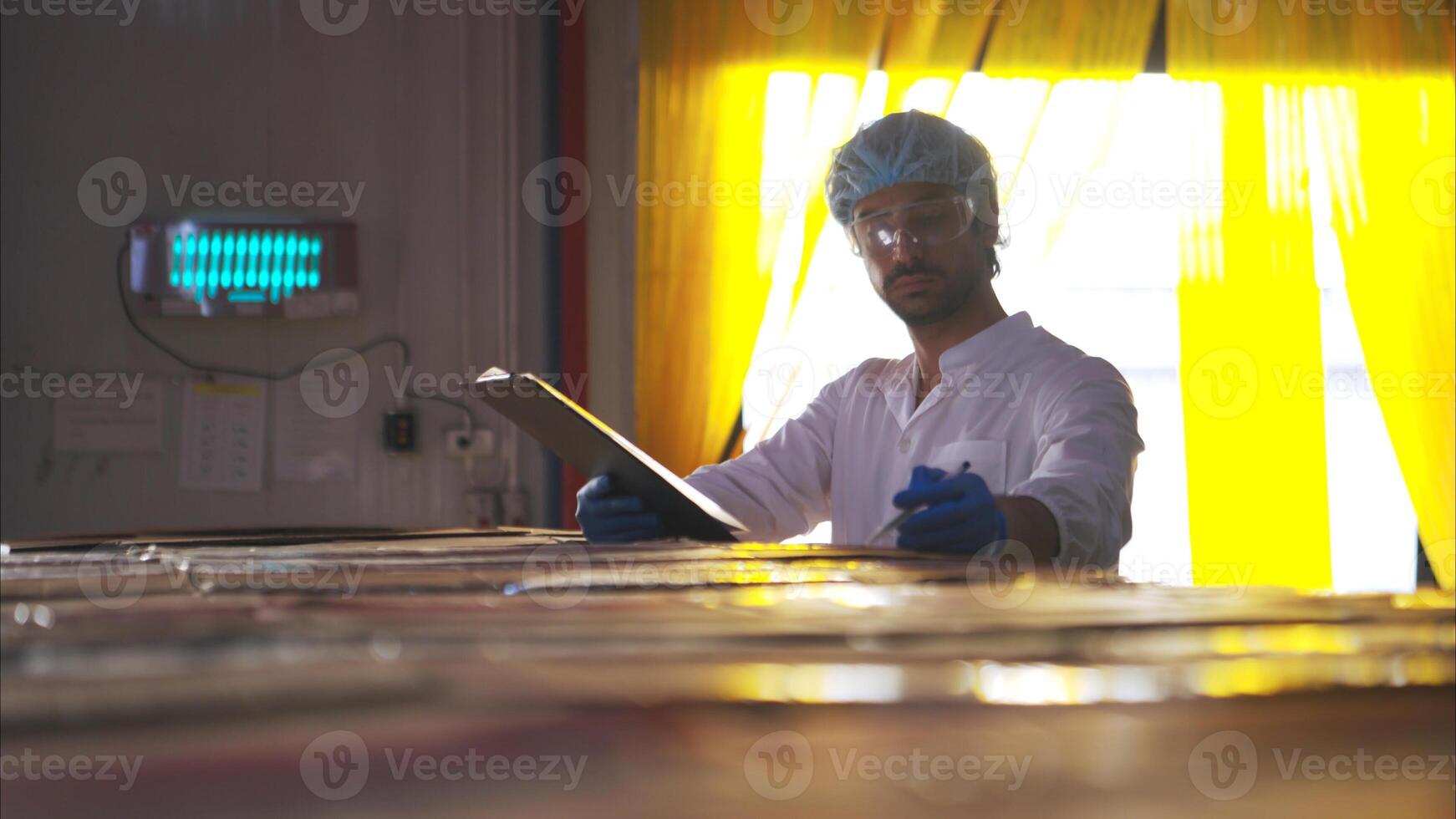 The production supervisor inspects the canned fish boxes that have gone through the packaging process photo
