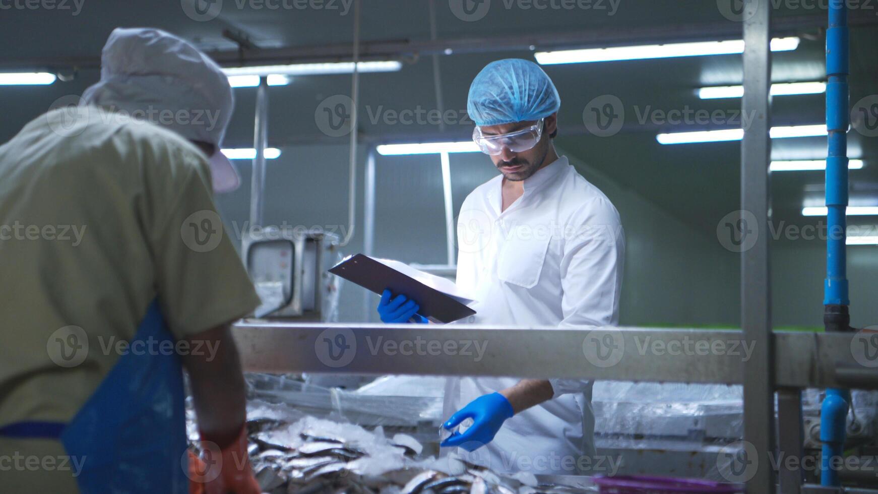 Raw material quality inspectors evaluate and inspect fish pieces before they enter the canned fish production process photo