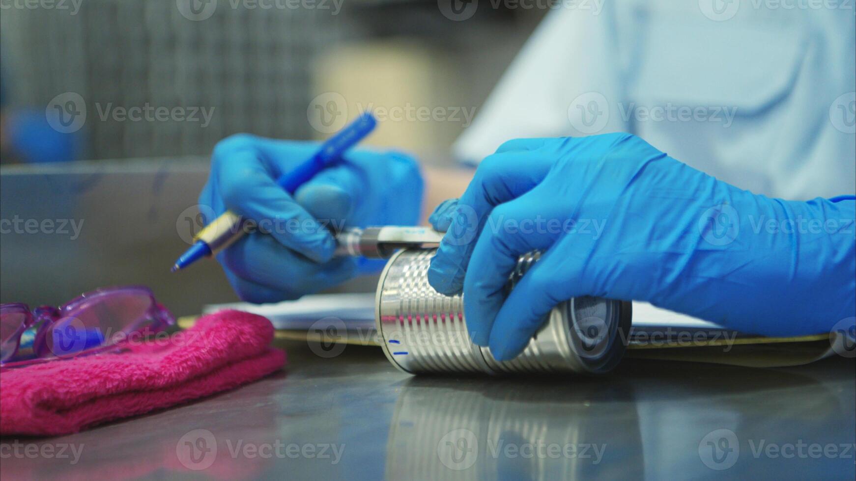 Production control supervisor inspects the can in the production line of a canned fish factory photo