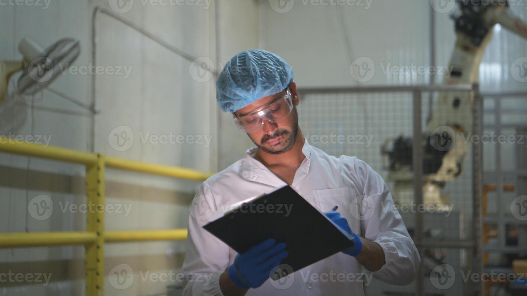 The production supervisor inspects the canned fish boxes that have gone through the packaging process photo