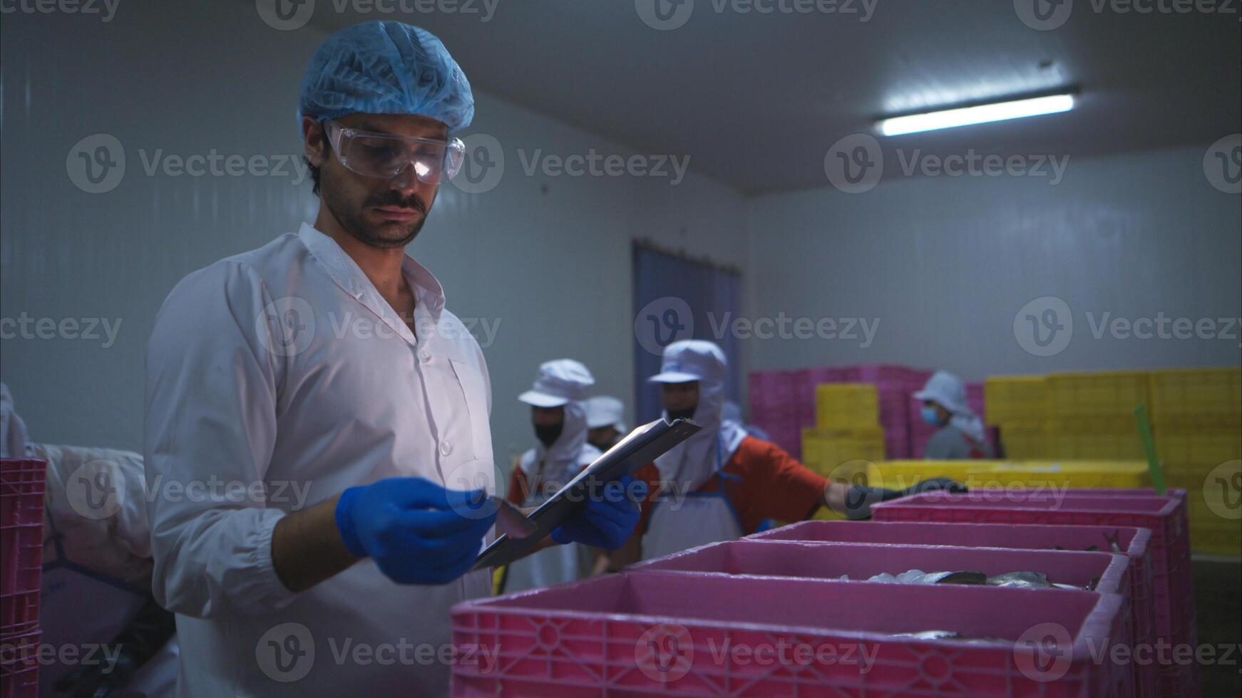 Raw material quality inspectors evaluate and inspect fish pieces before they enter the canned fish production process photo