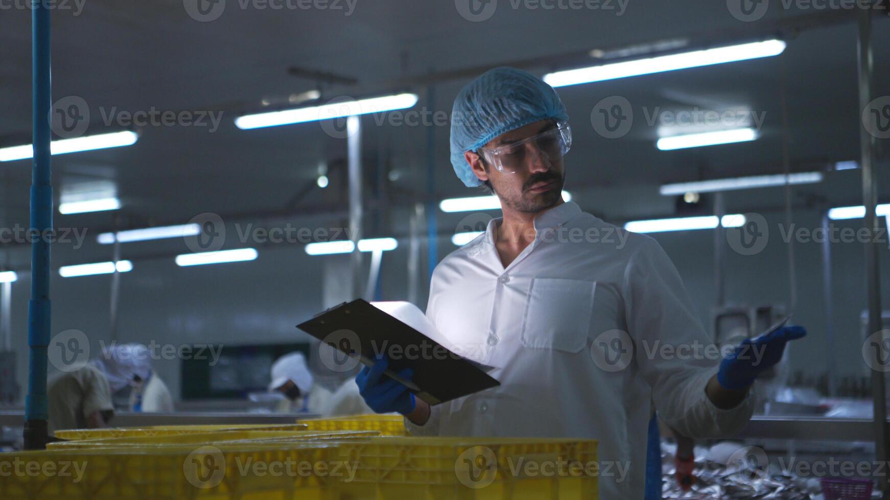 Raw material quality inspectors evaluate and inspect fish pieces before they enter the canned fish production process photo