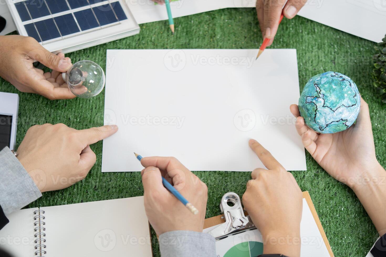 earth model represented idea of eco city was placed on green business meeting table with empty paper photo
