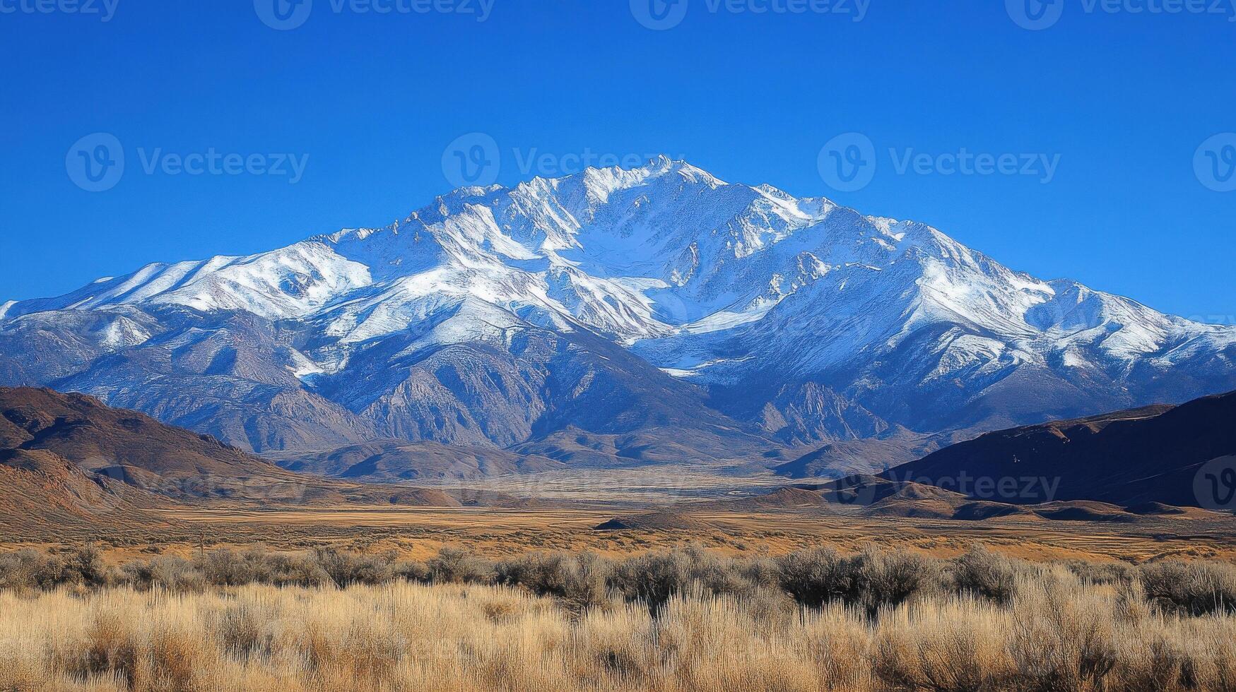 A mountain range with a snow capped peak photo