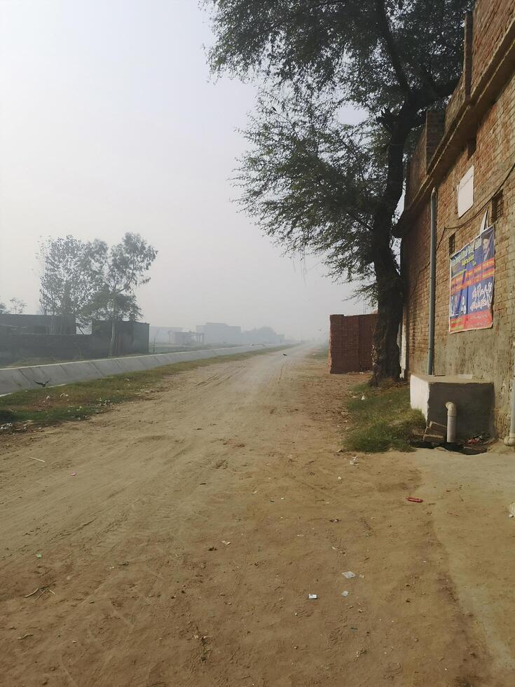 A dirt road with a sign on it photo