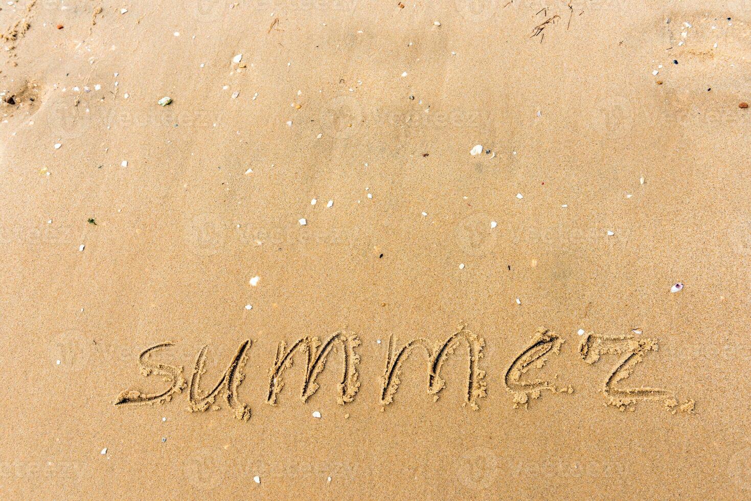 Summer written on the beach sand photo