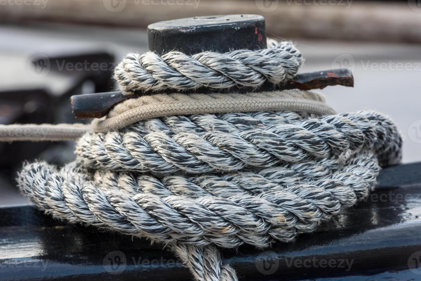 Mooring rope tied around a cleat photo