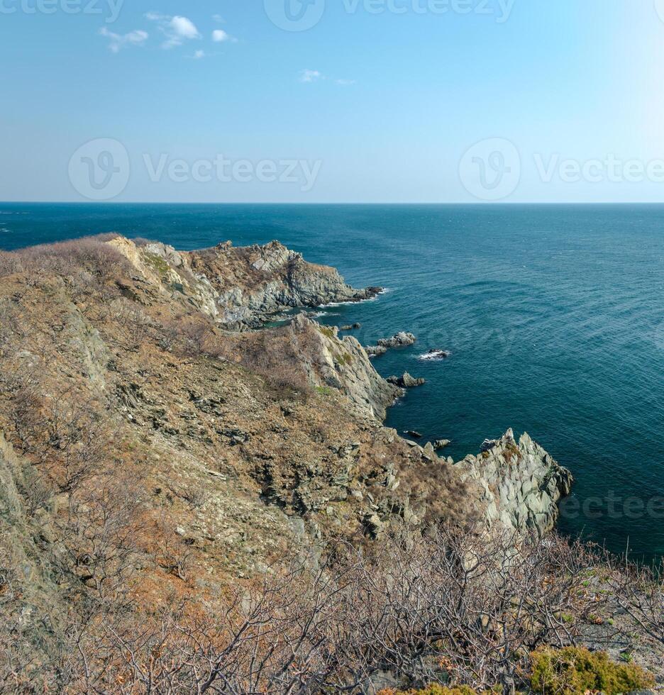 View of the vastness of the Pacific Ocean from the high seashore. High cliffs on the shore of the Pacific Ocean. photo