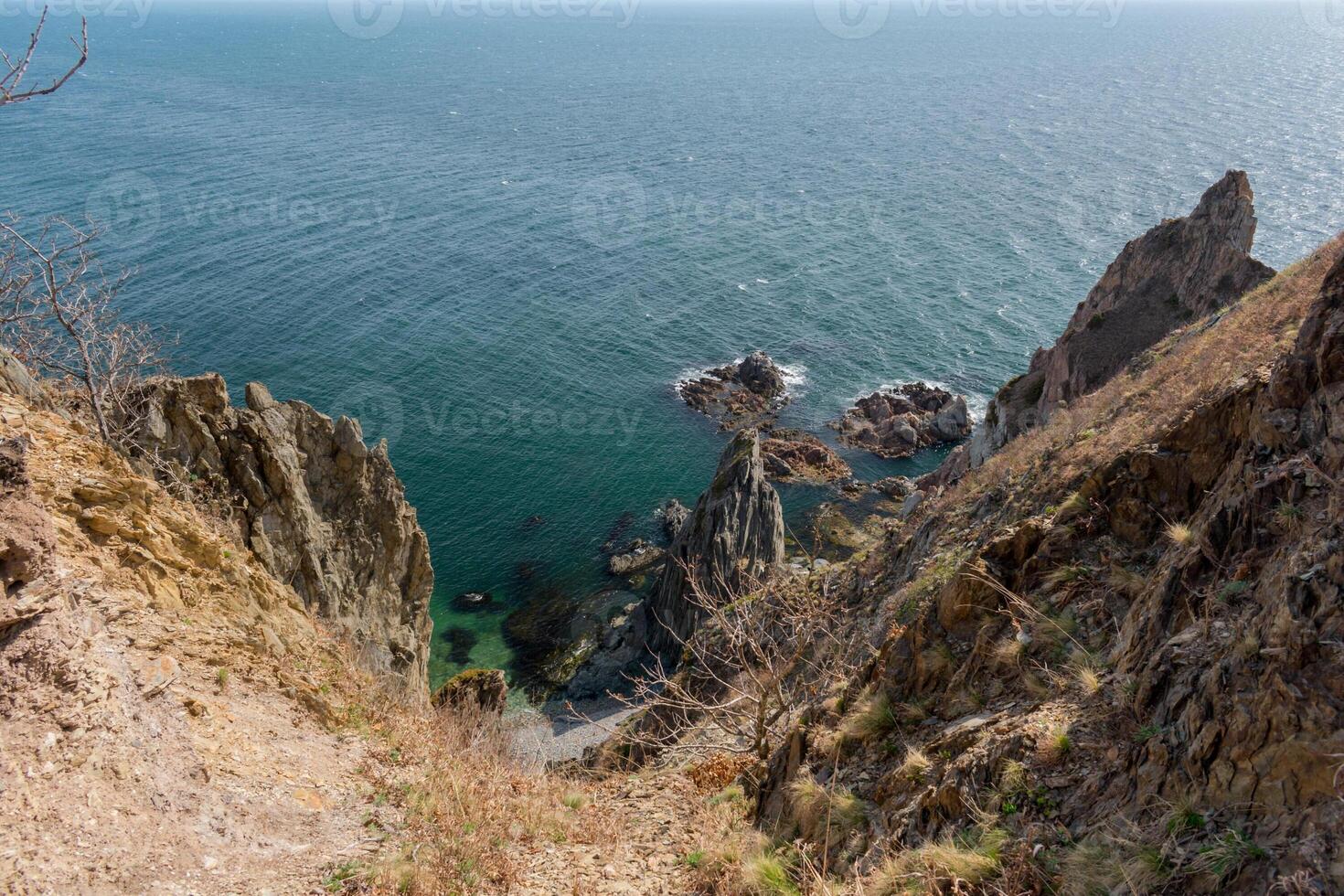 View of the vastness of the Pacific Ocean from the high seashore. High cliffs on the shore of the Pacific Ocean. photo