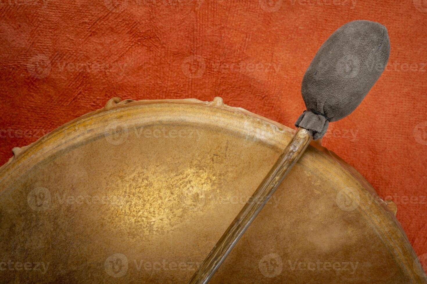 backlit, handmade, native American style, shaman frame drum covered by goat skin with a beater photo