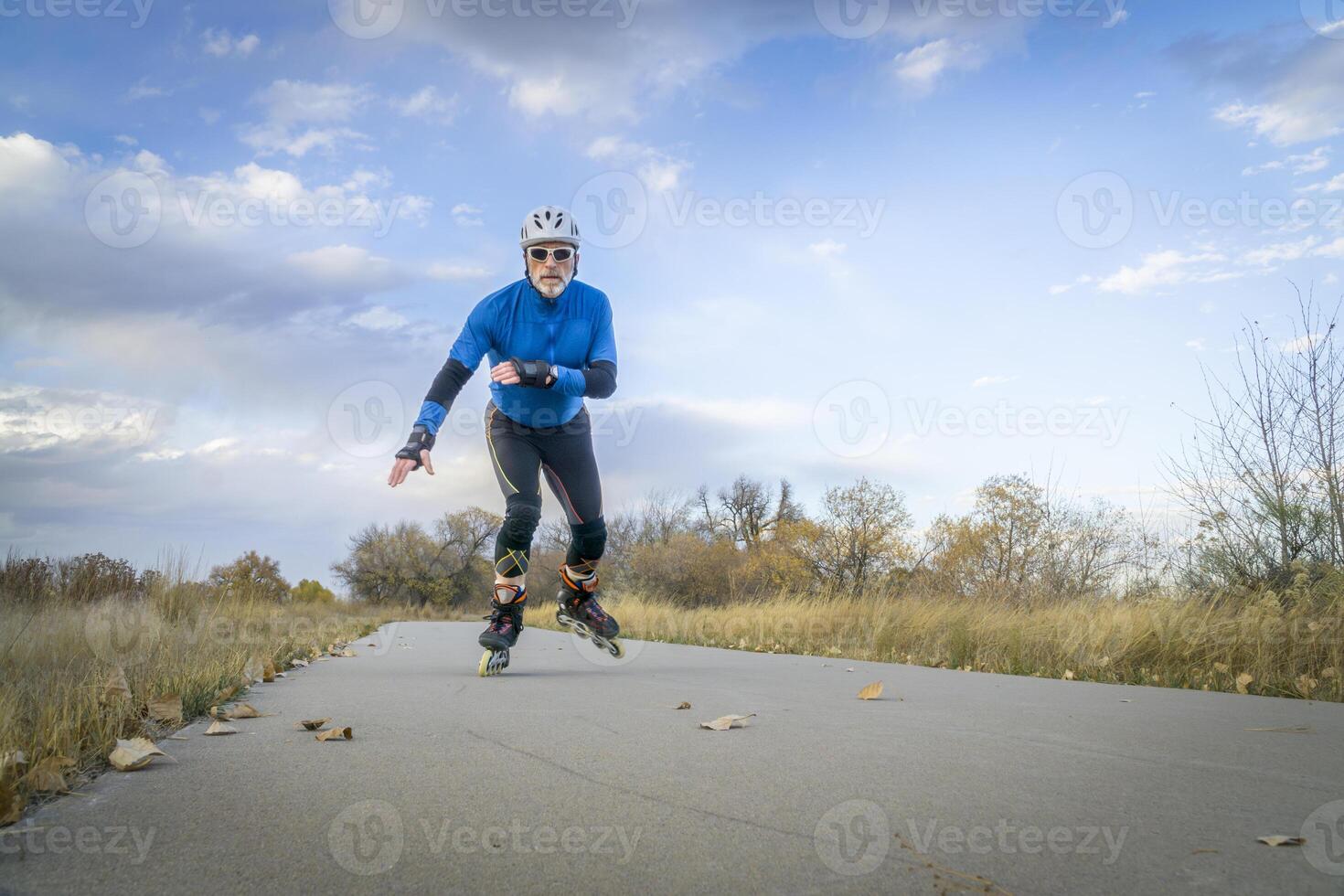 Senior athletic male inline skating on the Poudre RIver Trail in Colorado, late fall scenery photo