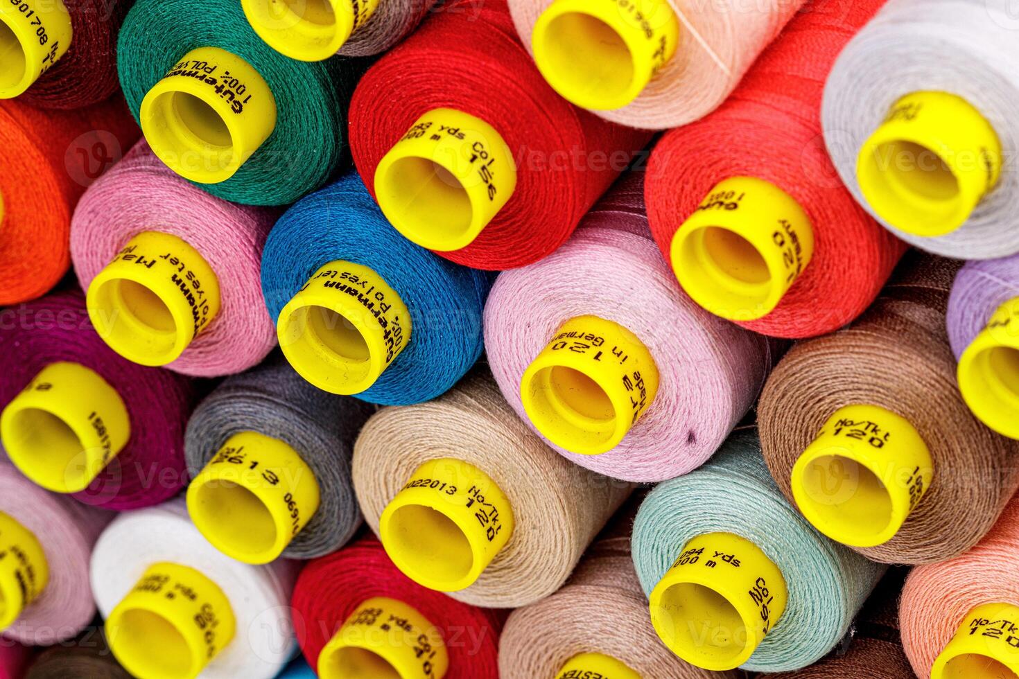 set of multi-colored spools of thread for sewing photo