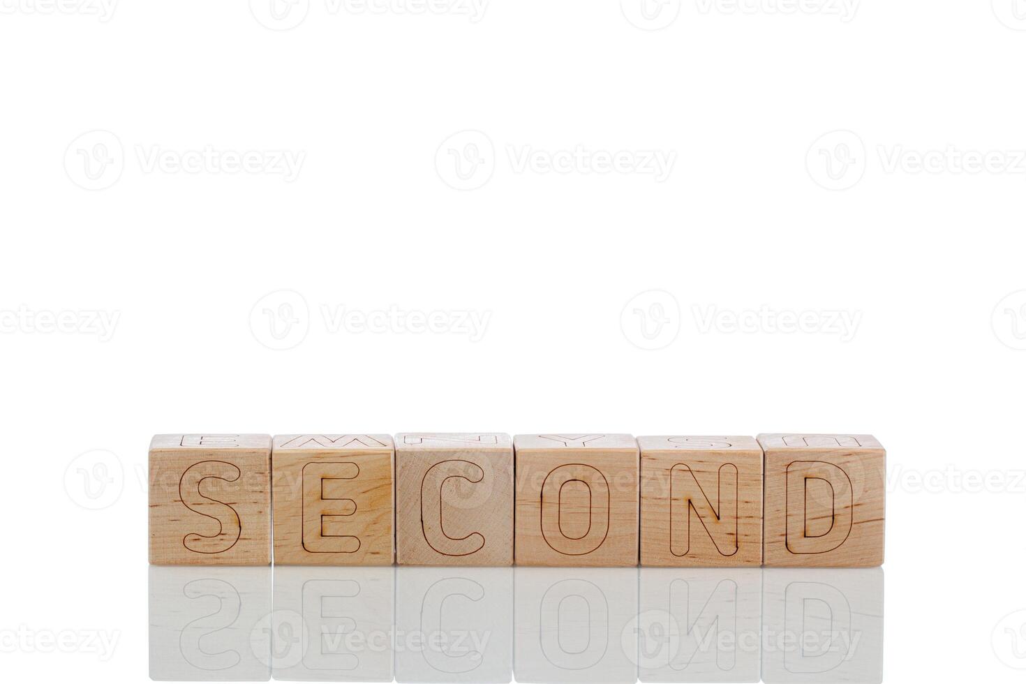 Wooden cubes with letters second on a white background photo