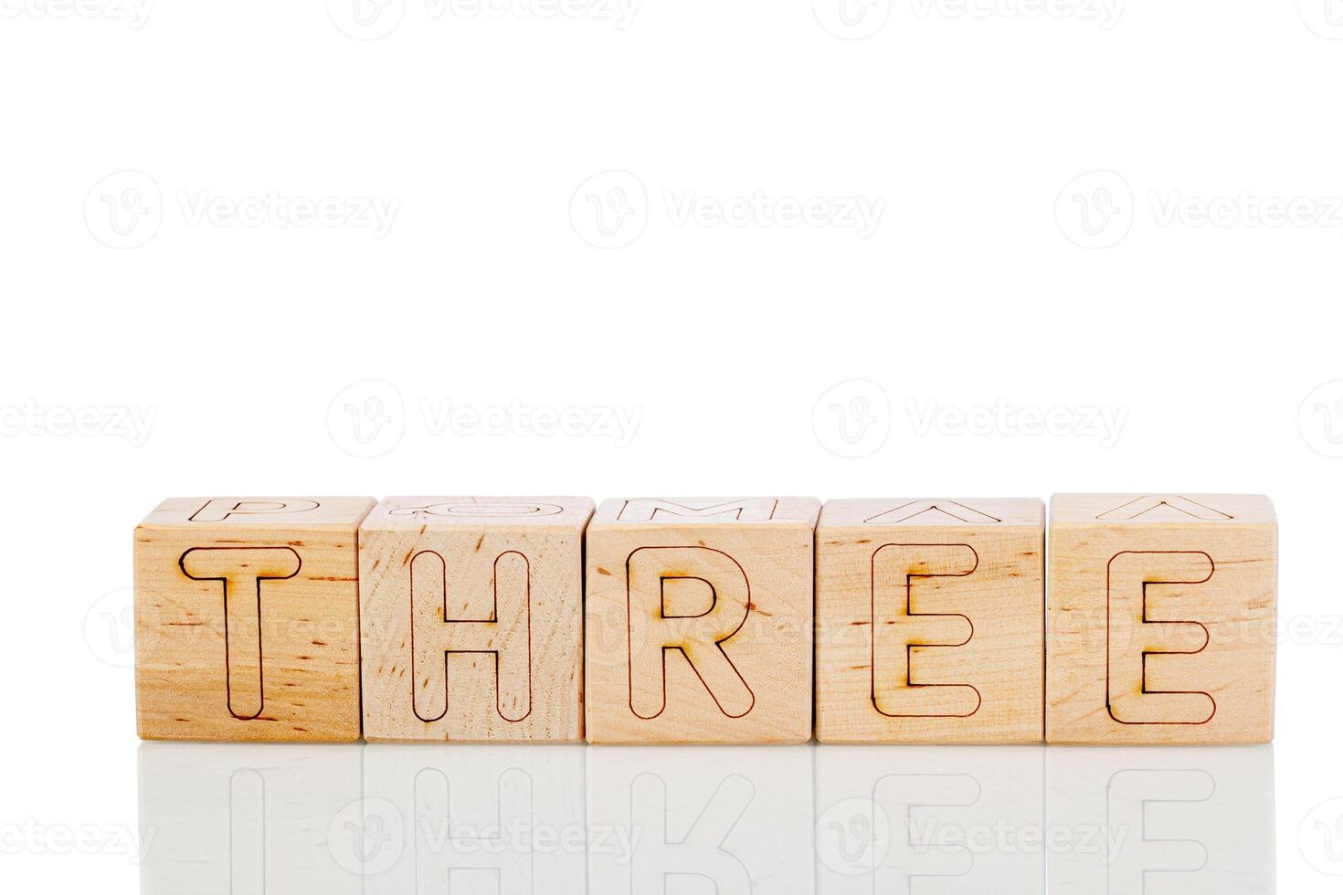 Wooden cubes with letters three on a white background photo