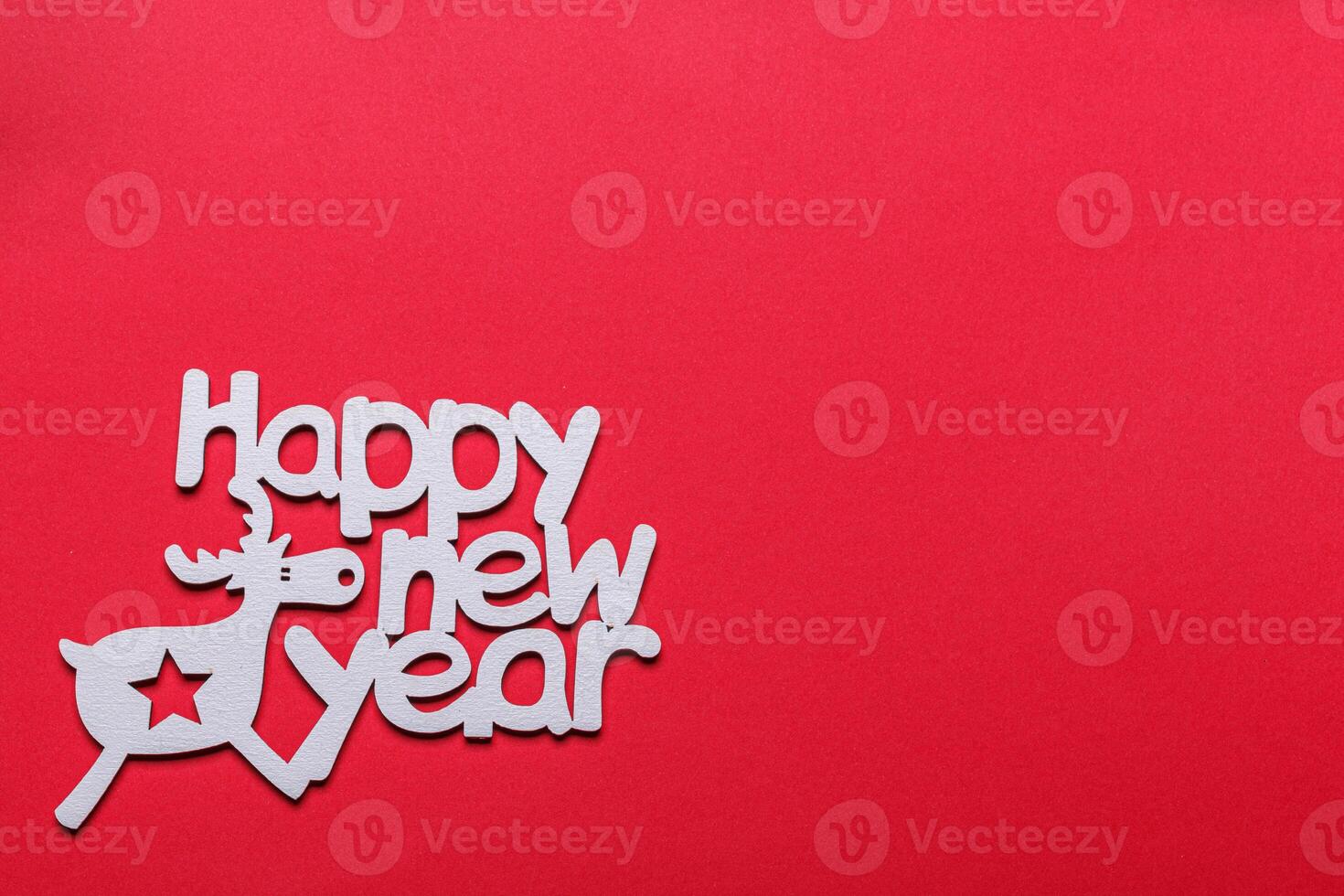 beautiful branches of a Christmas tree with cones and toys on a red background with the inscription Happy New Year photo