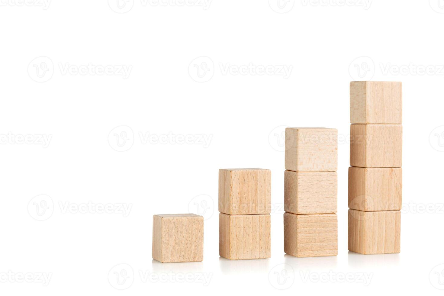 wooden cubes in the form of a ladder with a hand on an isolate white background photo