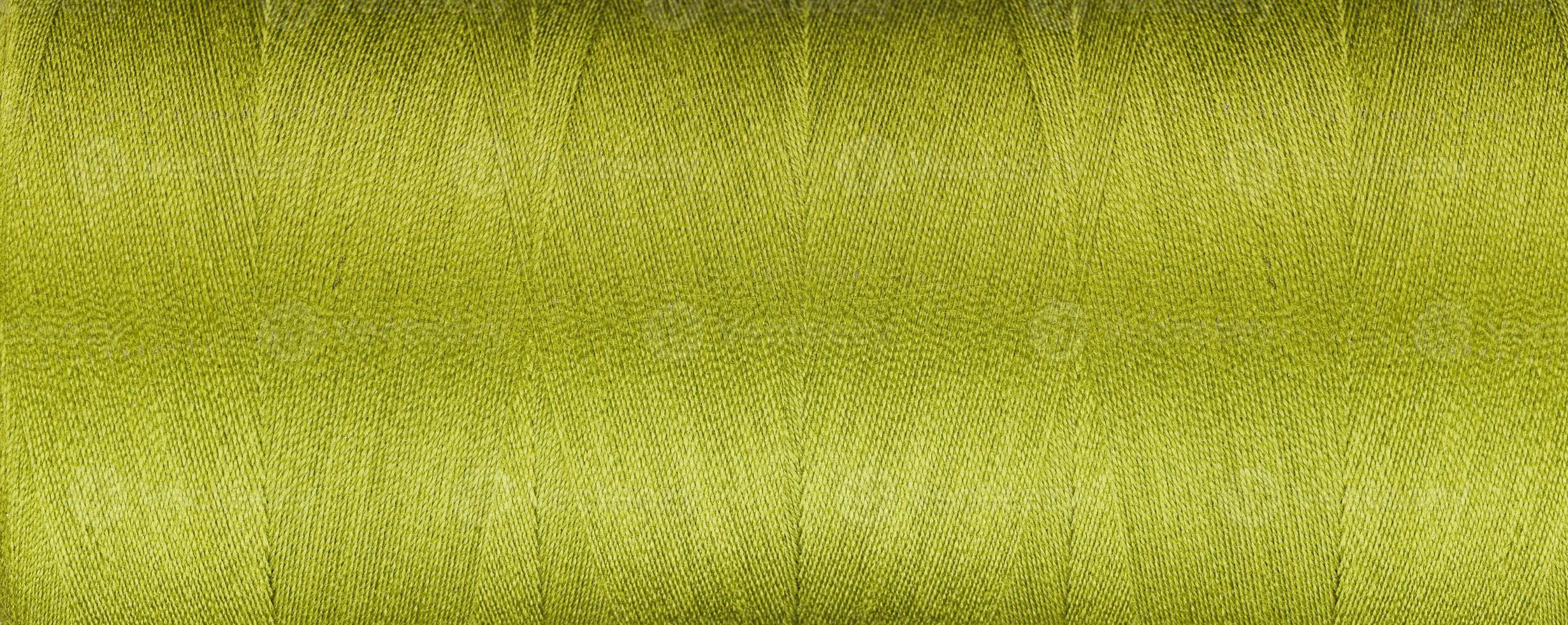 texture of thread for a sewing machine green color on a white background photo