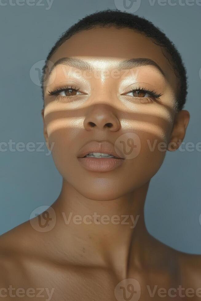 Female with illuminated face and shadows across eyes in natural light. photo